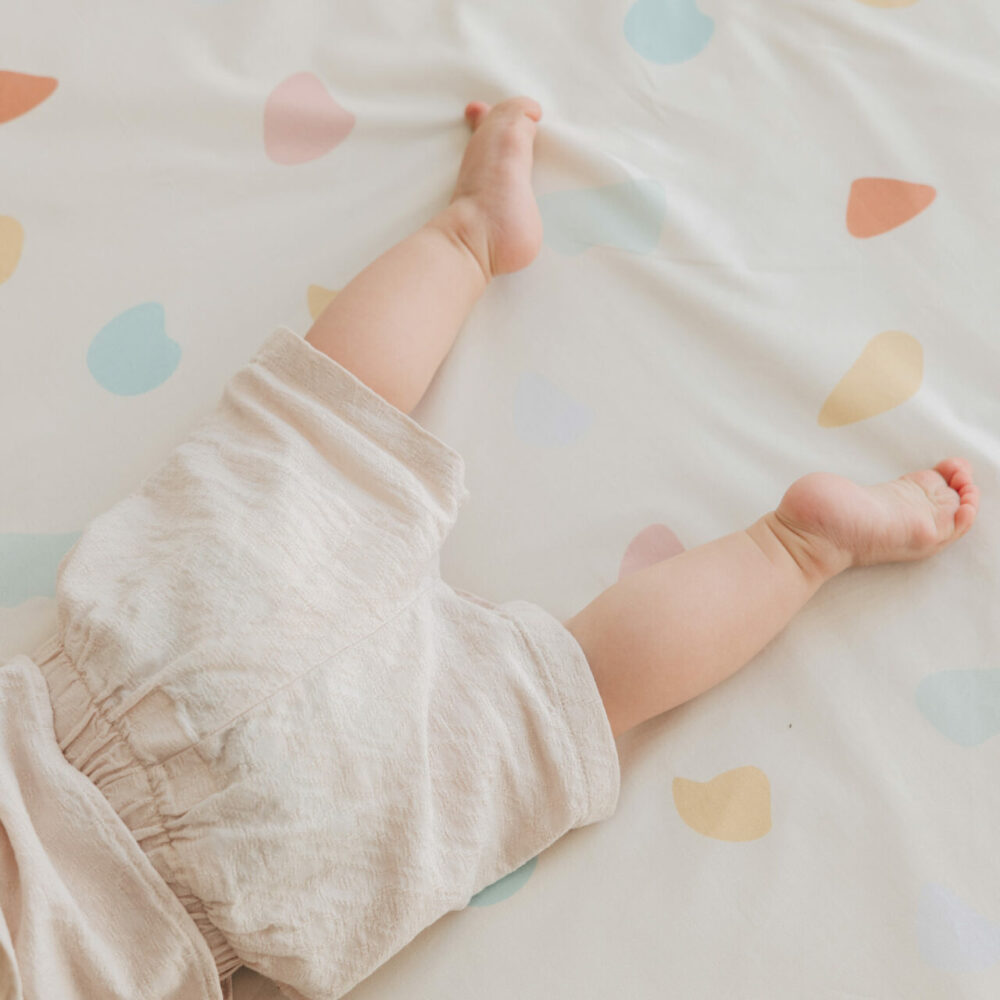 child's feet in pastel terrazzo